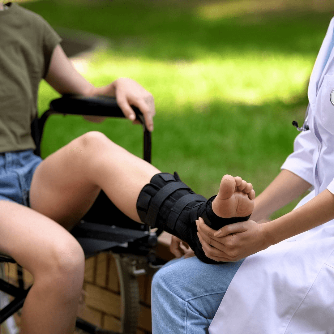 Ankle brace being fitted on a seated patient